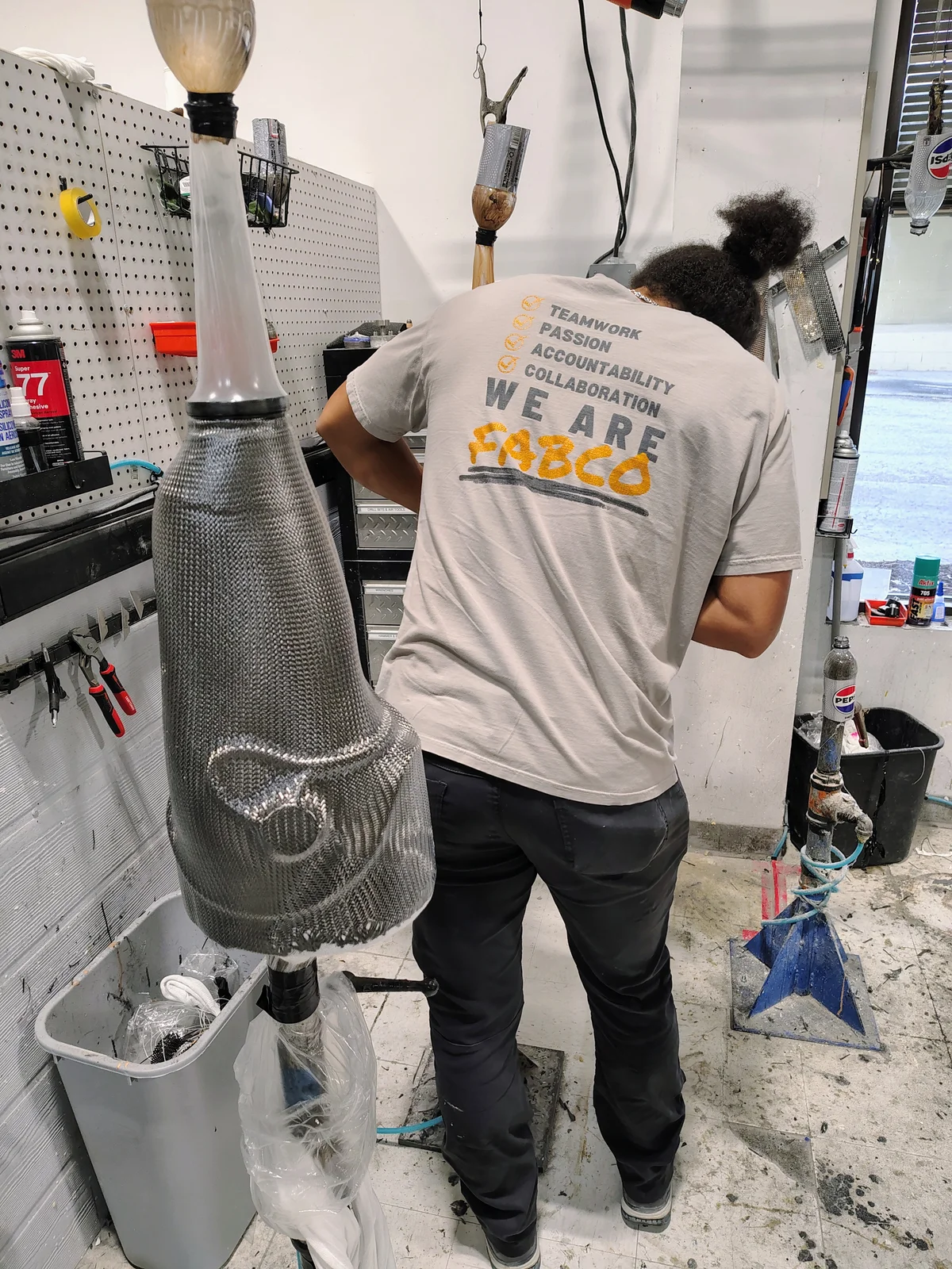 A FabCo technician laminating a prosthetic socket model