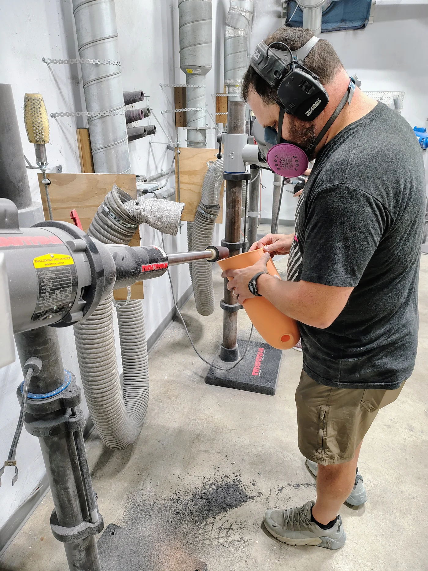 A FabCo technician applying the finish on the edge of a prosthetic socket