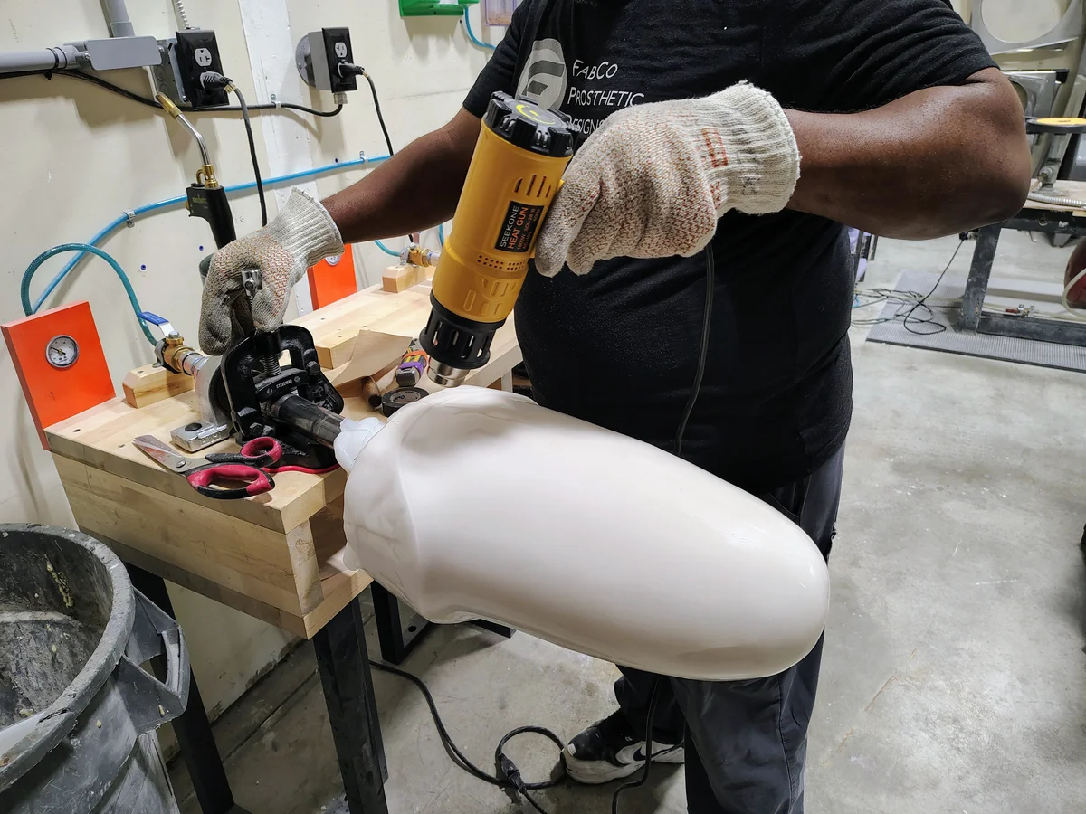 A FabCo fabricator heating and forming thermoplastic over a socket model