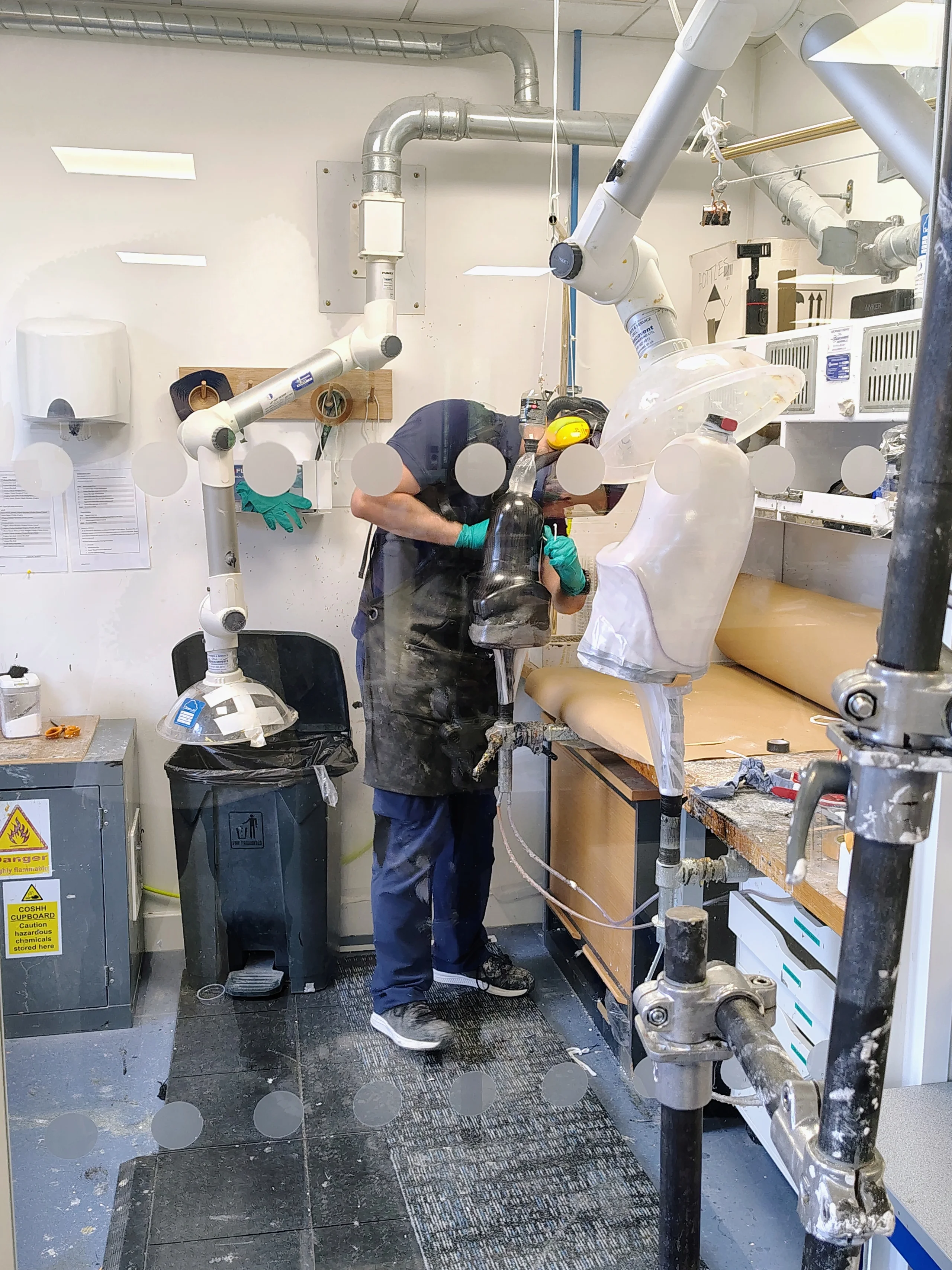 Equipment, extraction hoses, tools and socket components in the fabrication workshop.