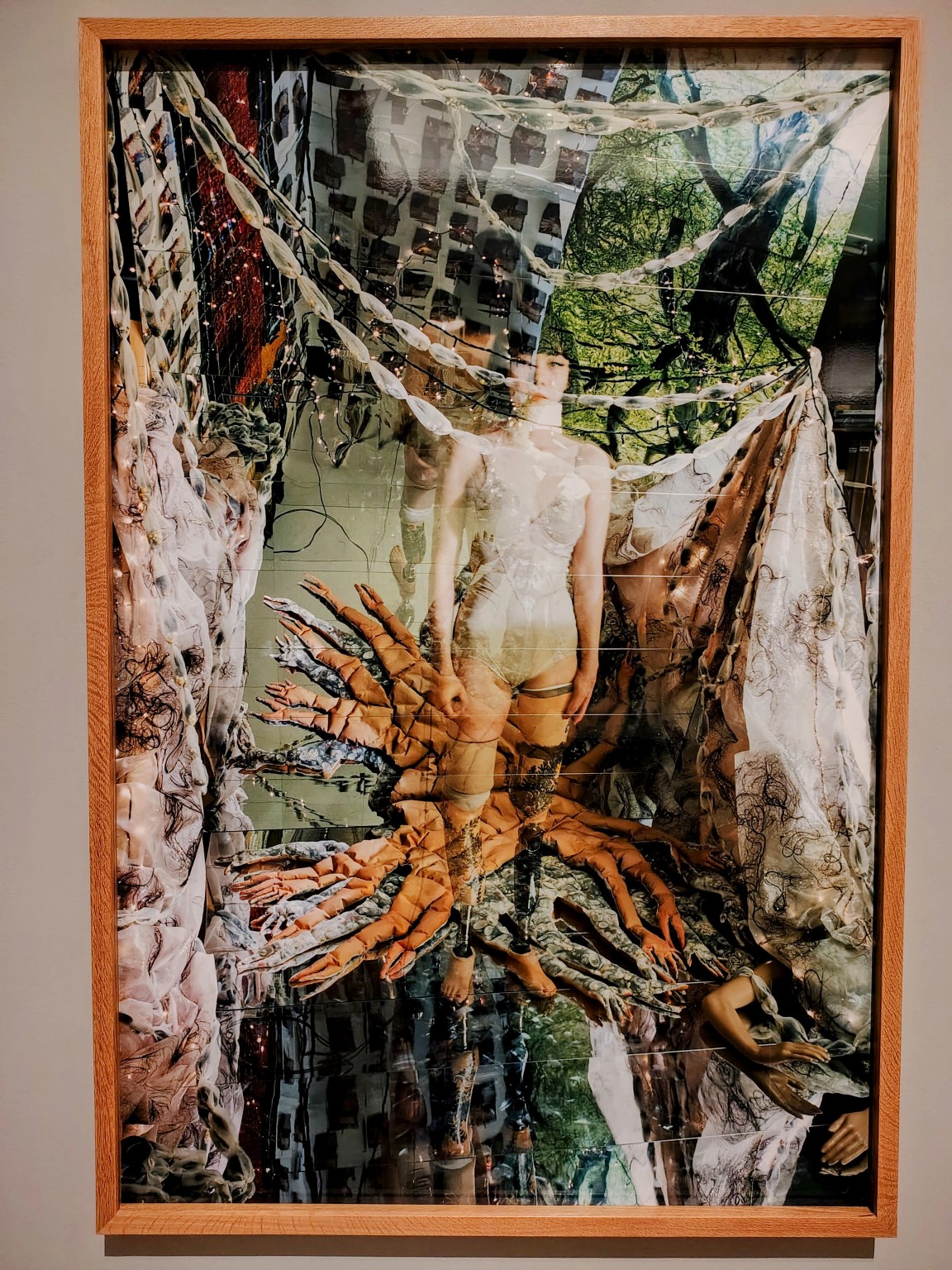 The artist surrounded by handsewn forms and mirrors in a photograph from tree of life.